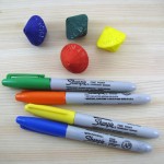 Variously-colored die, with markers used.