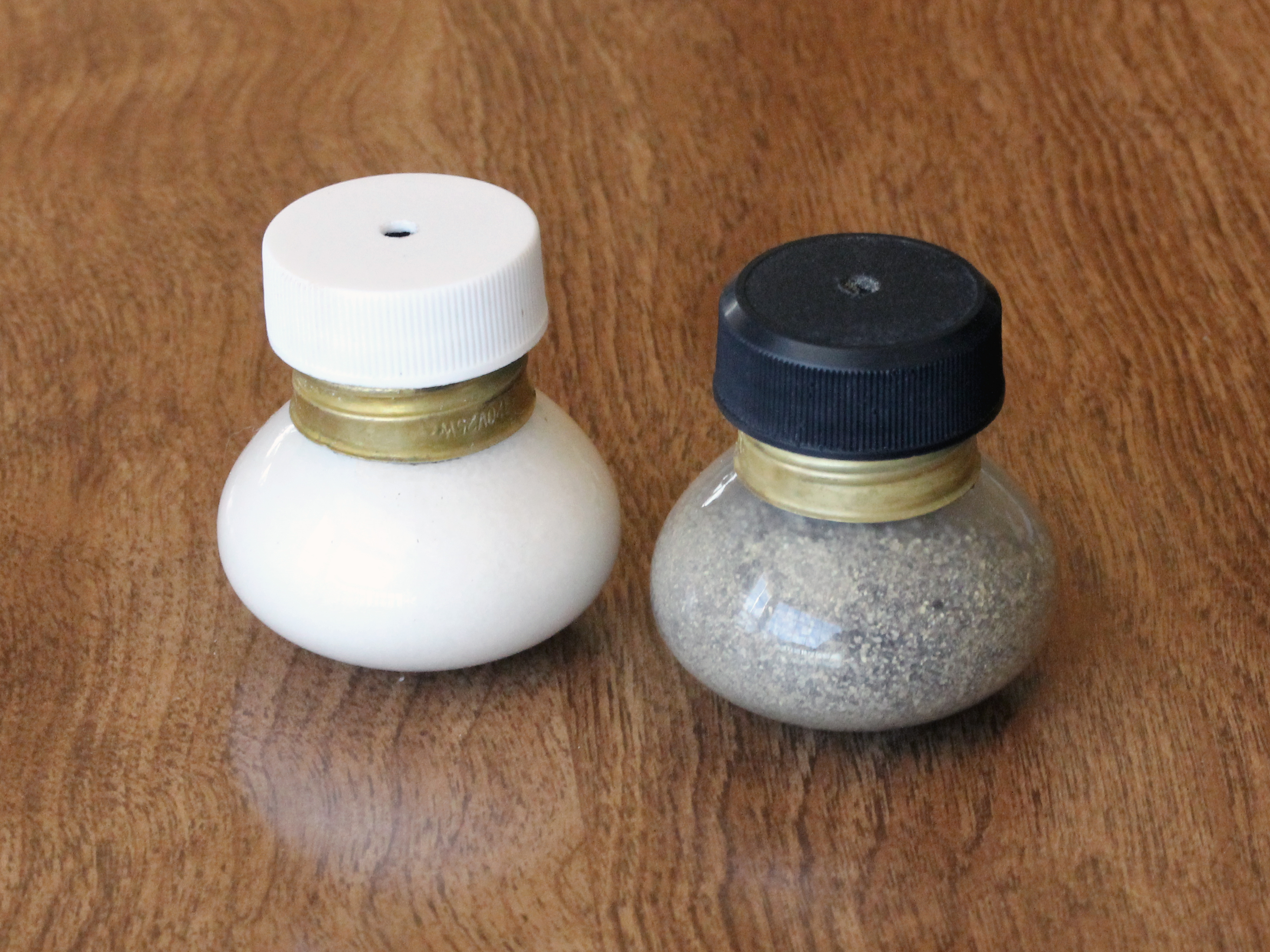 Salt-and-pepper shaker set made from small "floodlight" style light bulbs and two soda bottle caps.