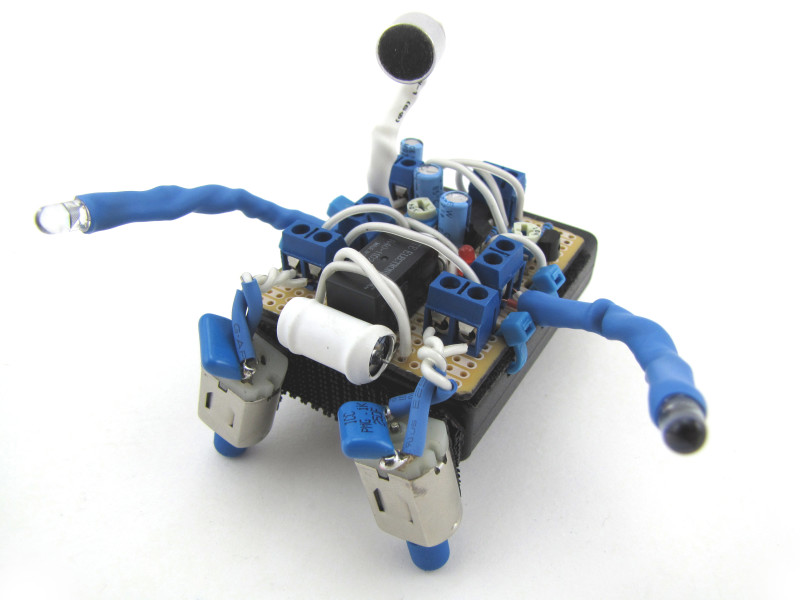 An elaborate but small hand-assembled BEAM style robot with carefullly coordinated colors in blue and white. 