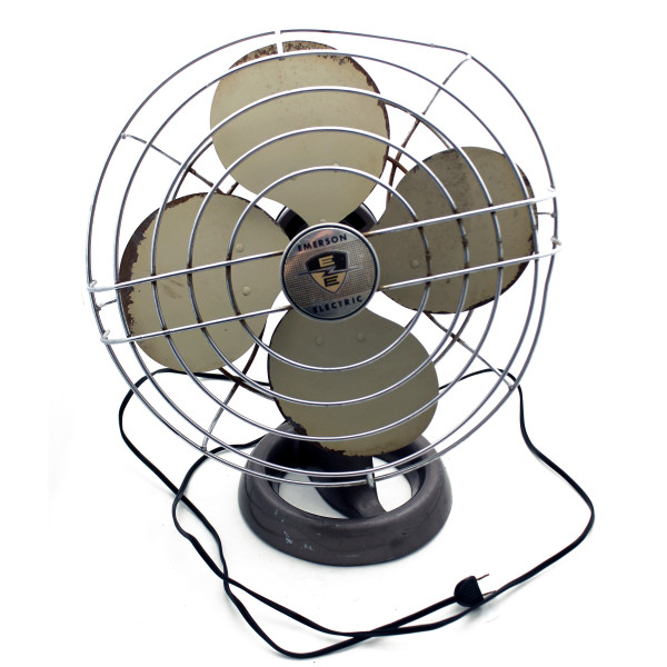 A front view of an all-metal oscillating desk fan with a wire cage. The cage is bent out of shape and the blades show some rust around the edges.